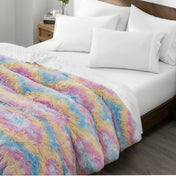 Shaggy duvet cover on a bed with white pillows and a wooden headboard.