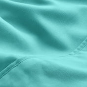 A close-up of microfiber fabric with soft folds and a visible stitched seam.