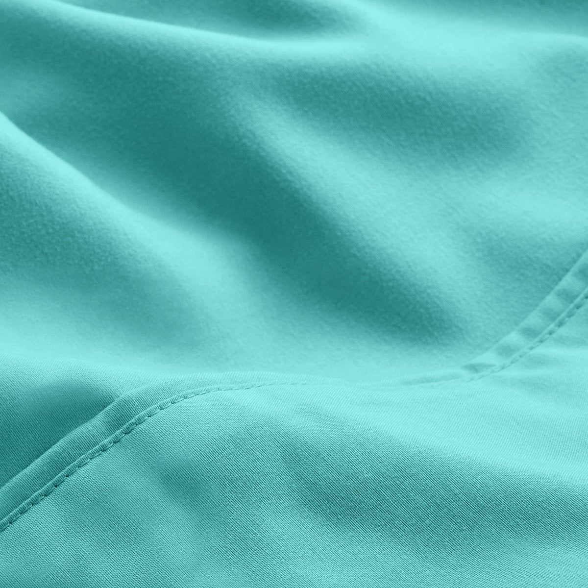 A close-up of microfiber fabric with soft folds and a visible stitched seam.