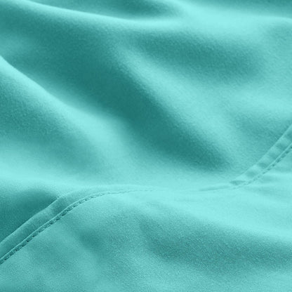 A close-up of microfiber fabric with soft folds and a visible stitched seam.