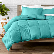 A modern bed with a down alternative comforter set on it