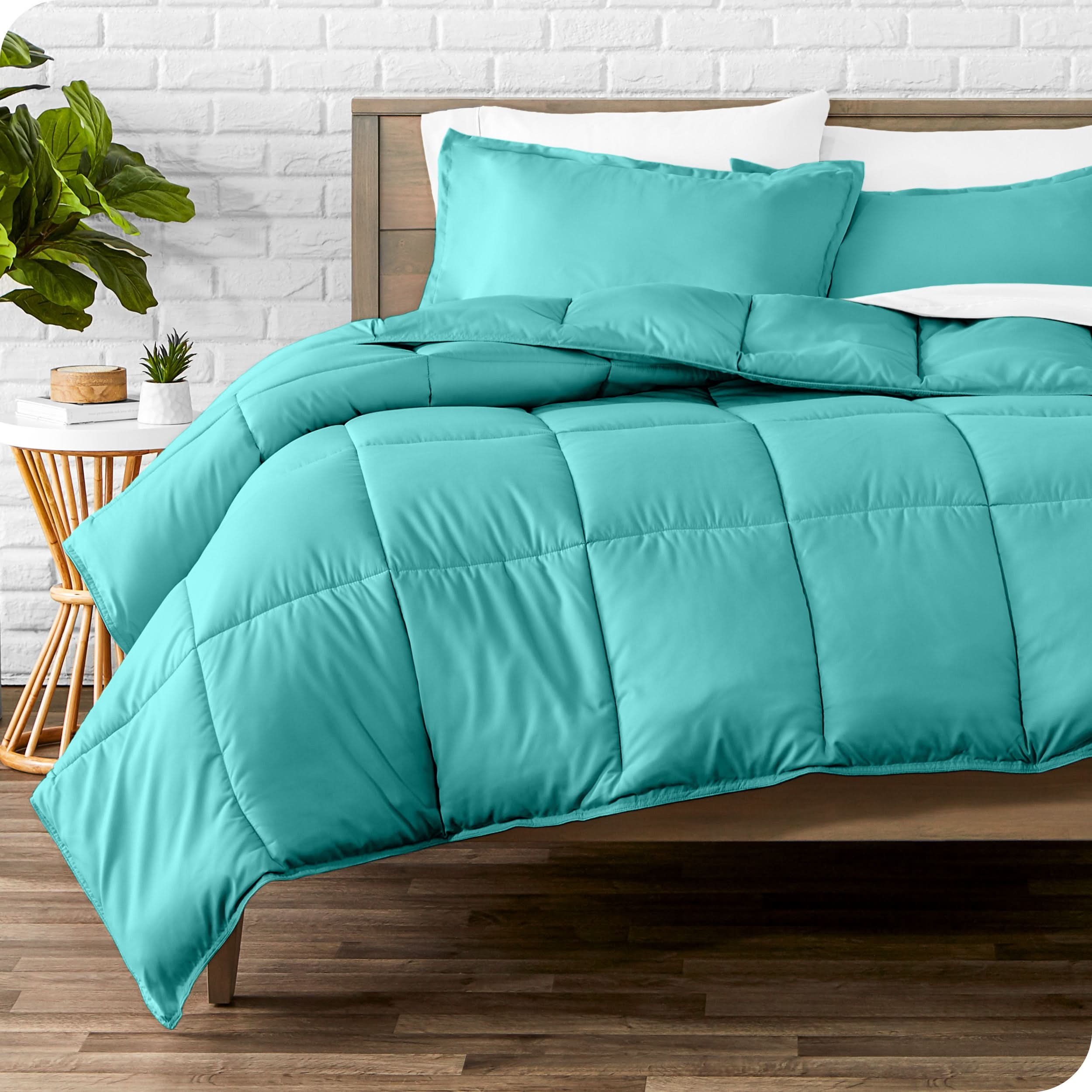 A modern bed with a down alternative comforter set on it