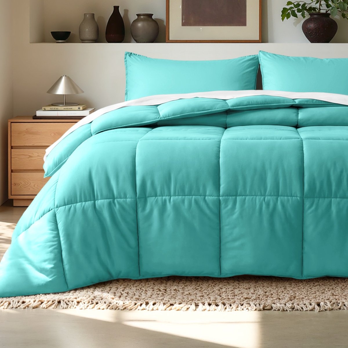 Comforter on a bed in a bedroom setting with a wooden nightstand and decorative items.