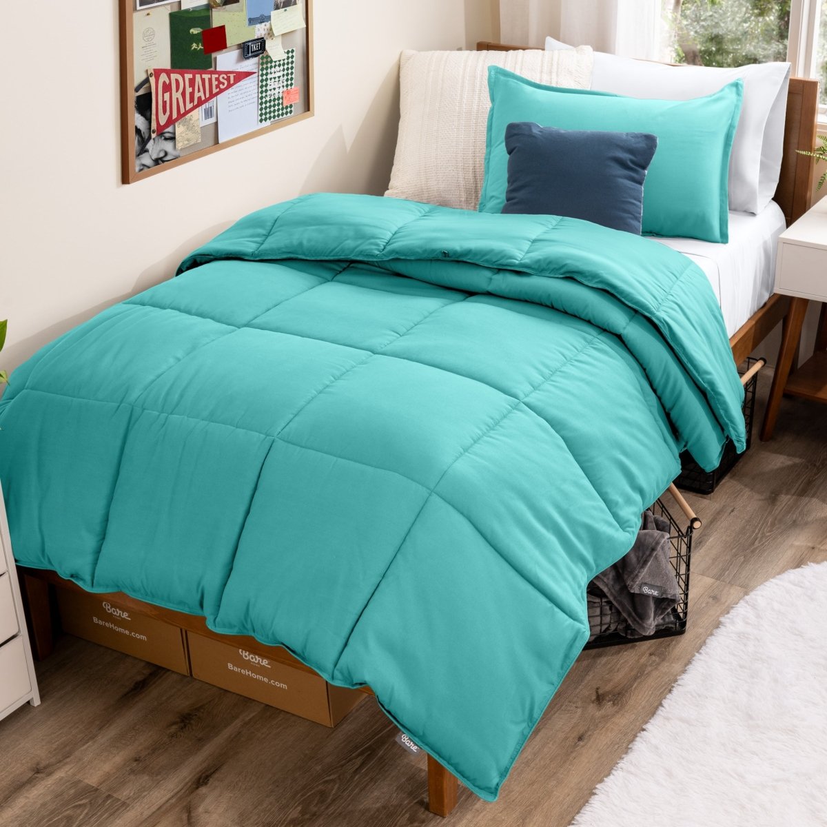 Bed with comforter and pillows in a dorm room