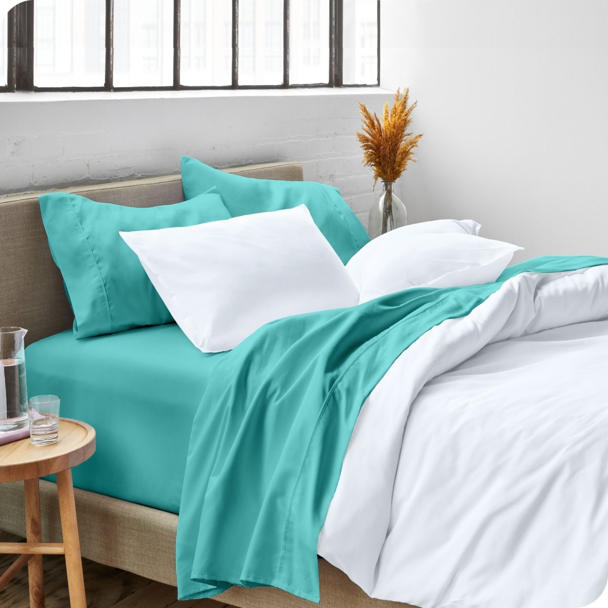 A side view of a bed made with microfiber sheets and a white duvet cover