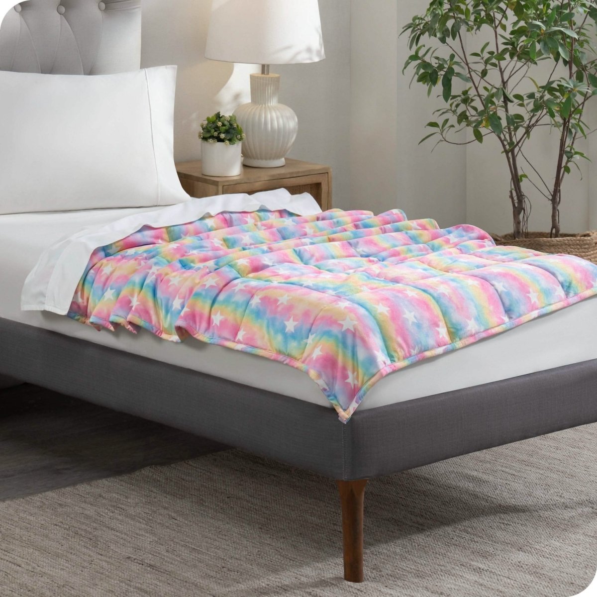 A weighted blanket laid out on a bed.