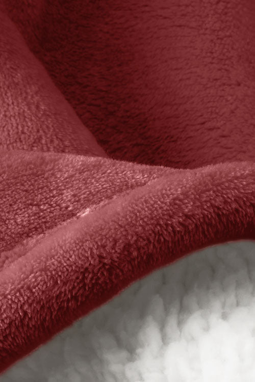 rose colored sheets with a white blanket and a tray with a coffee on it