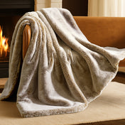 Blanket draped over a chair in front of a fireplace