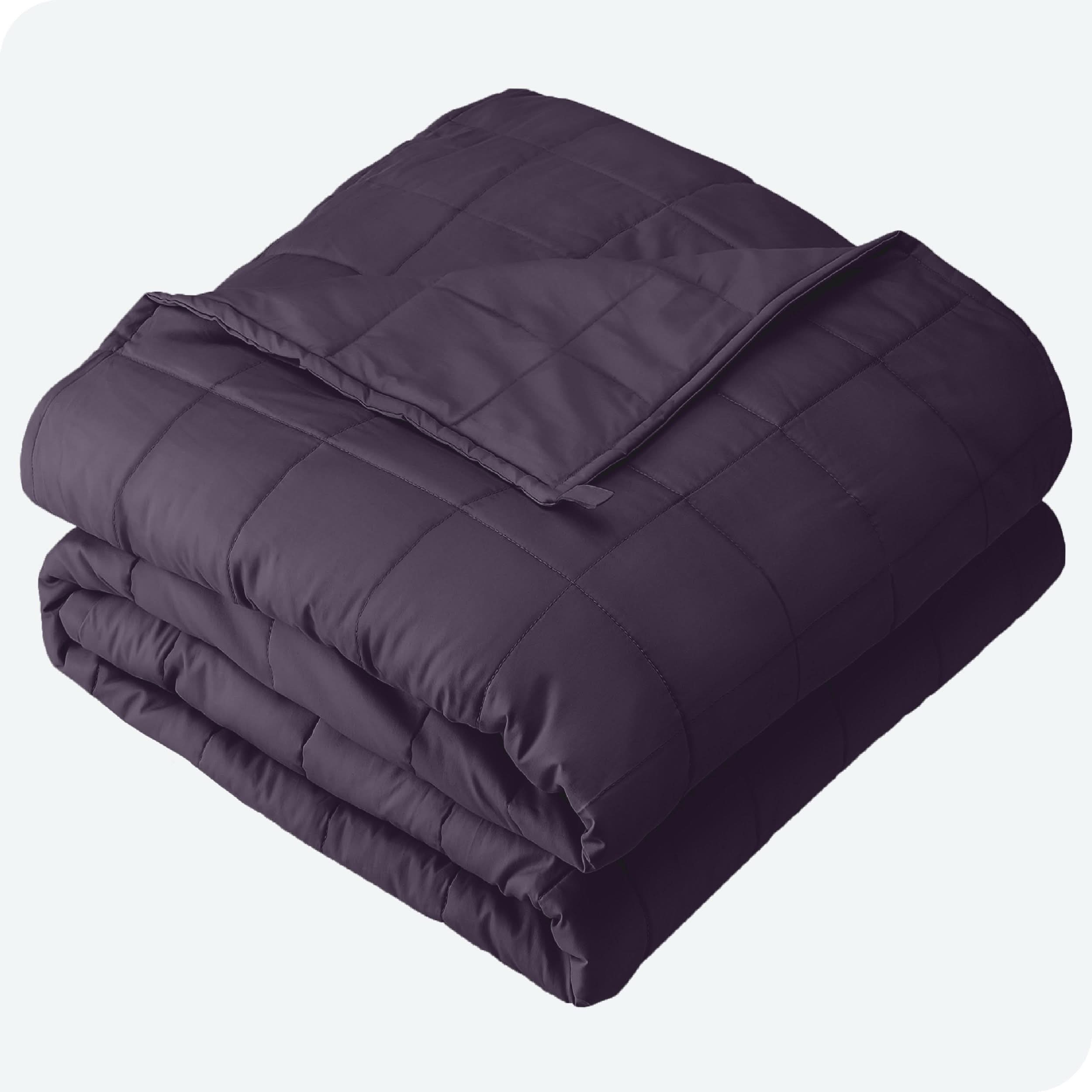 A folded cotton weighted blanket with a white background.