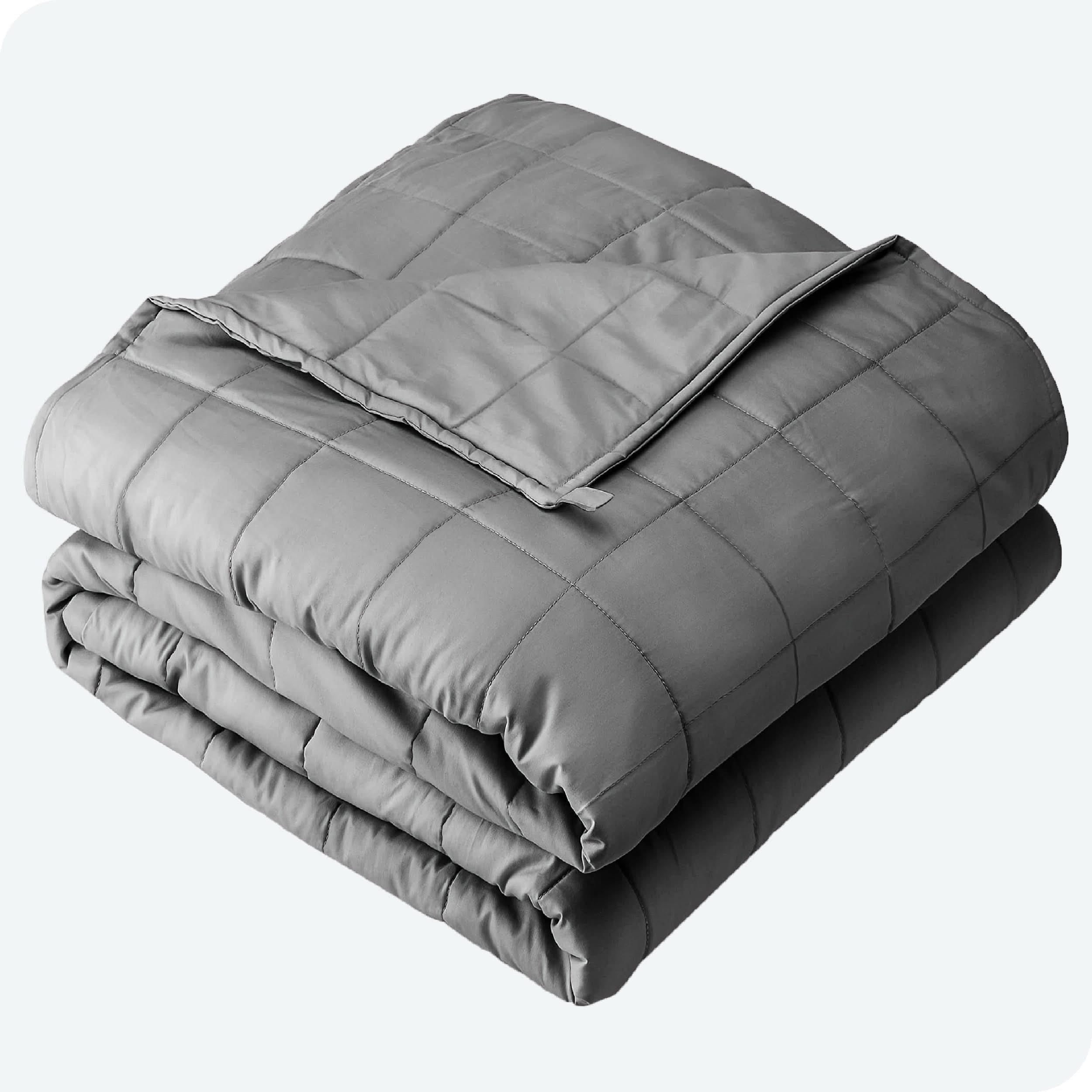 A folded cotton weighted blanket with a white background.