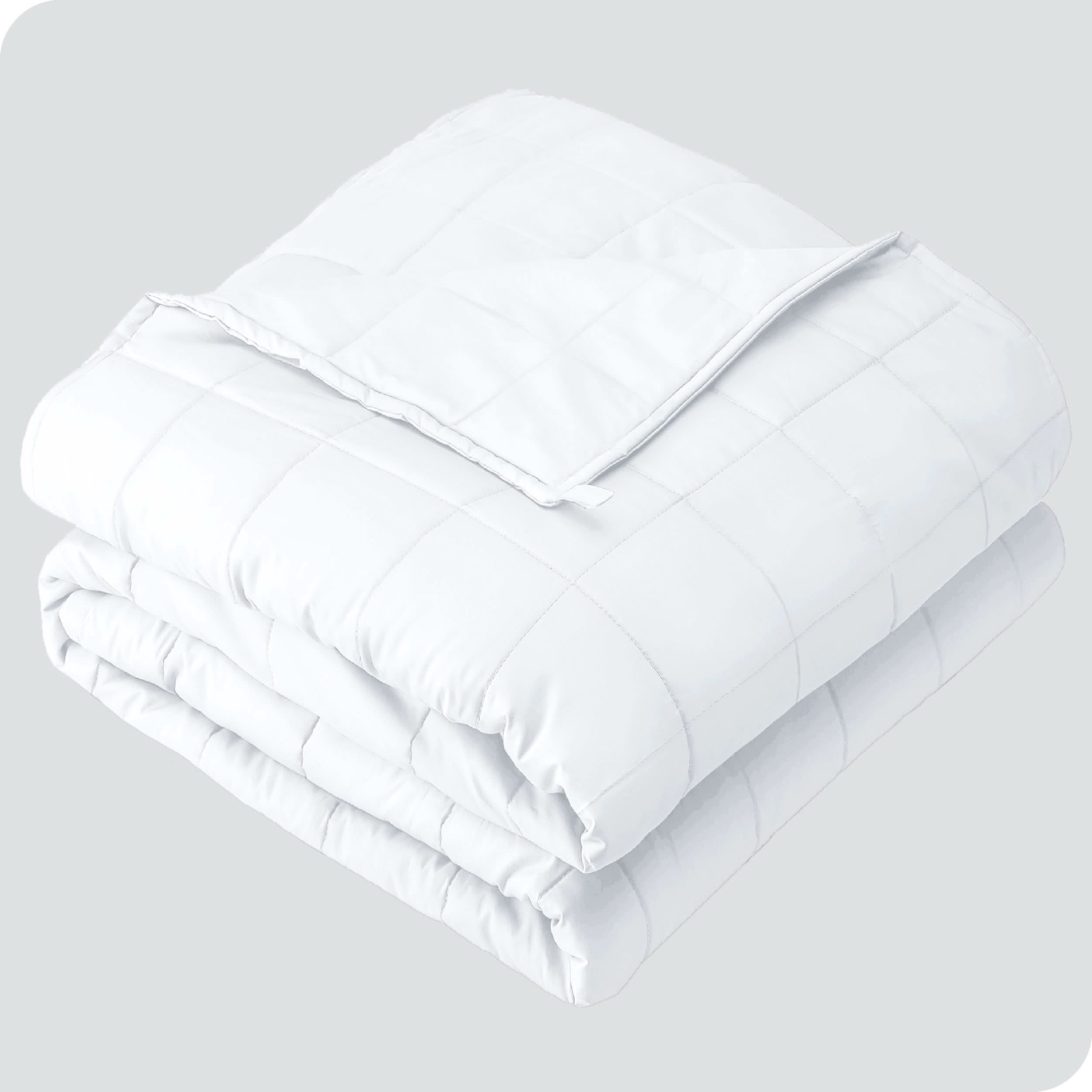 A folded cotton weighted blanket with a white background.