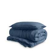 Washed duvet cover and sham set folded and stacked on a white background