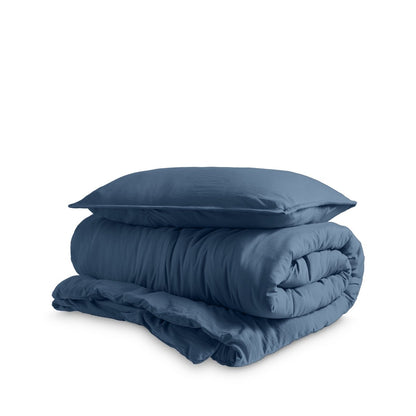 Washed duvet cover and sham set folded and stacked on a white background