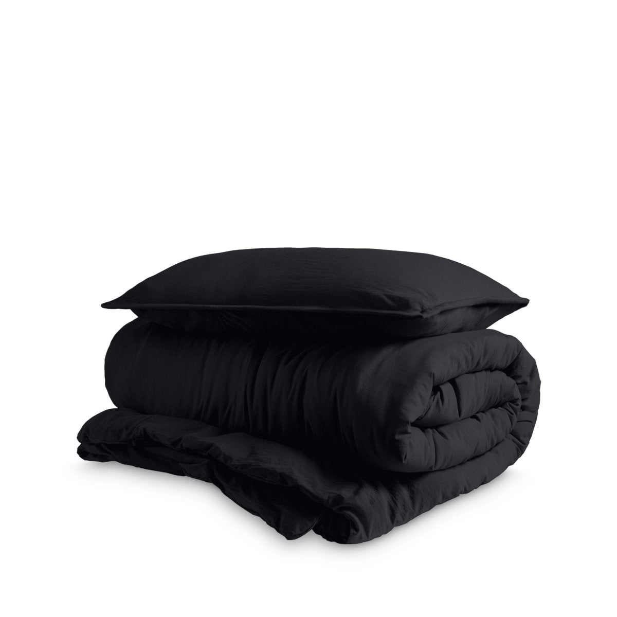Washed duvet cover and sham set folded and stacked on a white background