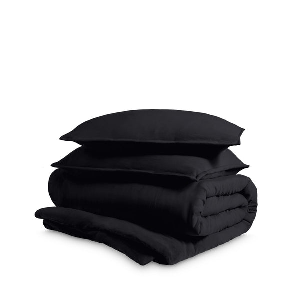 Washed duvet cover and sham set folded and stacked on a white background