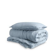 Washed duvet cover and sham set folded and stacked on a white background