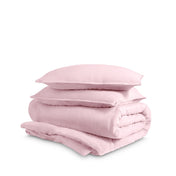 Washed duvet cover and sham set folded and stacked on a white background