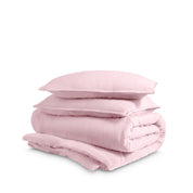 Washed duvet cover and sham set folded and stacked on a white background