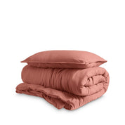 Washed duvet cover and sham set folded and stacked on a white background