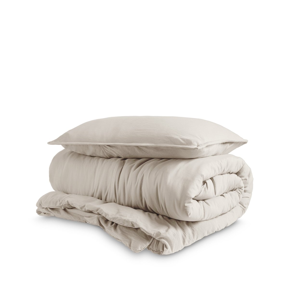Washed duvet cover and sham set folded and stacked on a white background