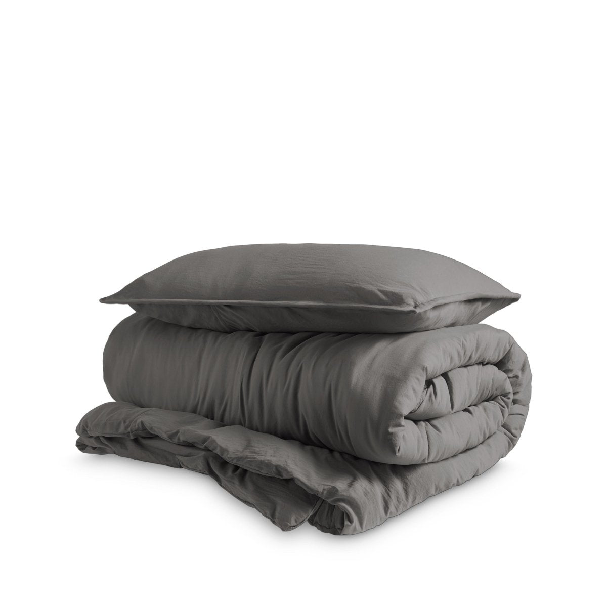 Washed duvet cover and sham set folded and stacked on a white background