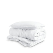 Washed duvet cover and sham set folded and stacked on a white background