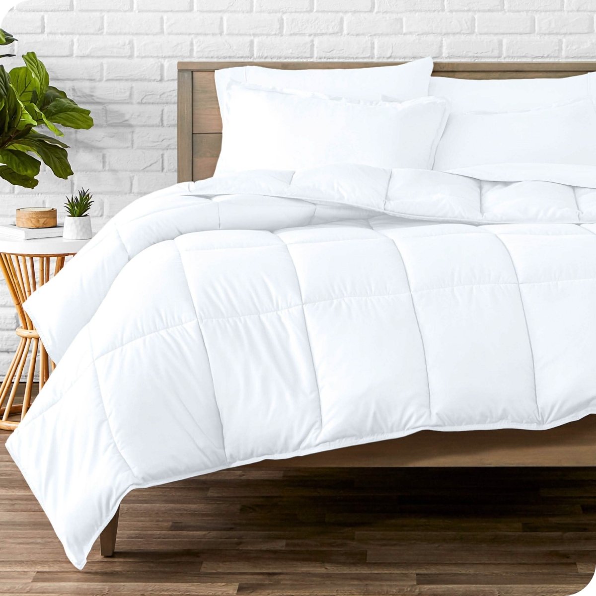A modern bedroom with microfiber sheets and a comforter on the bed