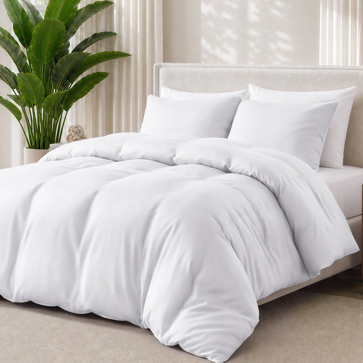 White bedding set on a bed with a plant in the background
