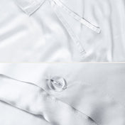 Close-up of the corner ties and button closure on a duvet cover