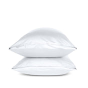 Two white pillows stacked on a white background