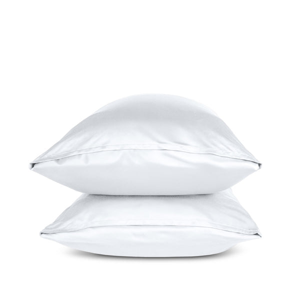 Two white pillows stacked on a white background