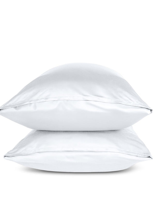 Two white pillows stacked on a white background