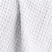 Close up of the fabric of a cotton waffle blanket