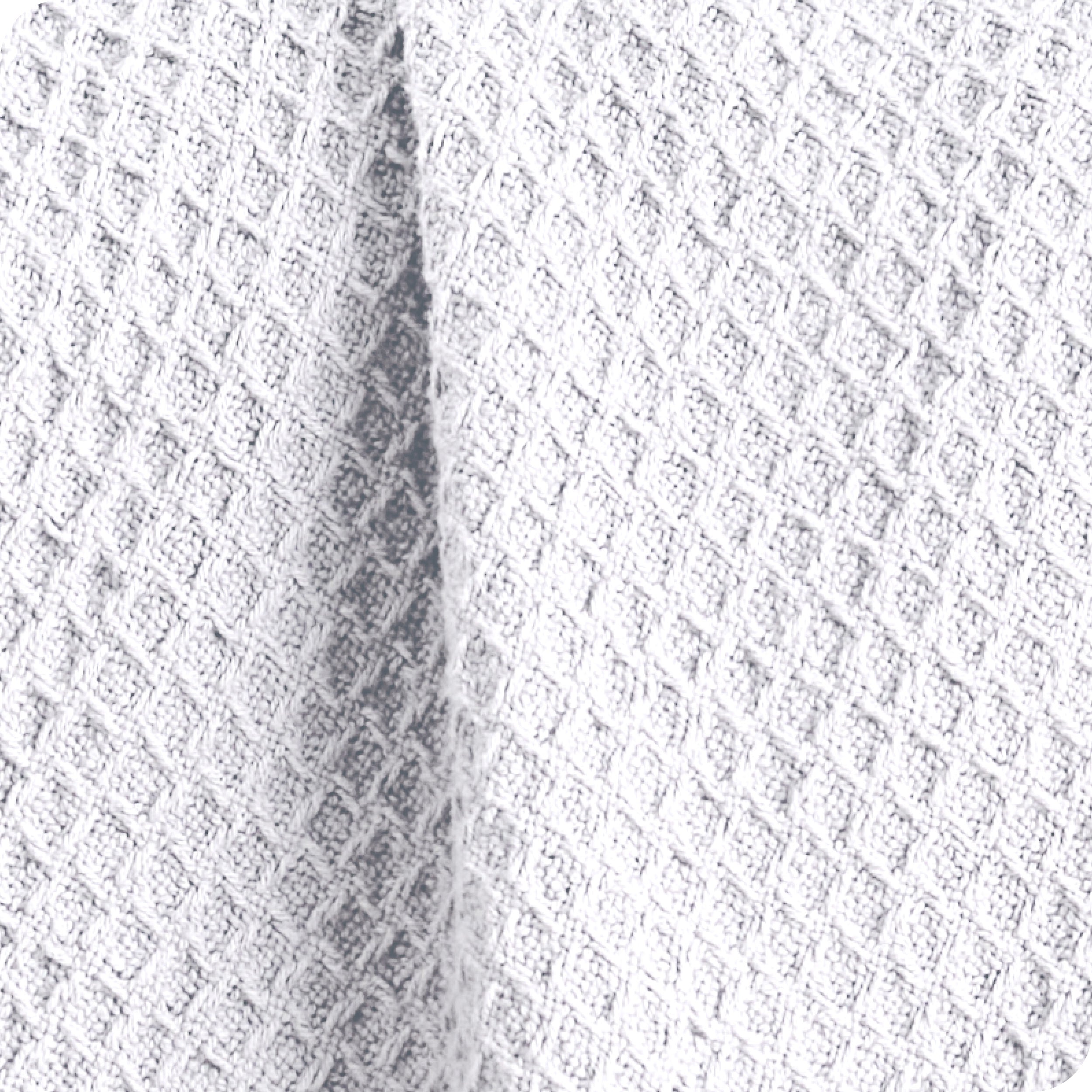 Close up of the fabric of a cotton waffle blanket