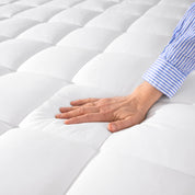 Close up of a cotton mattress pad showing the box-stitching.