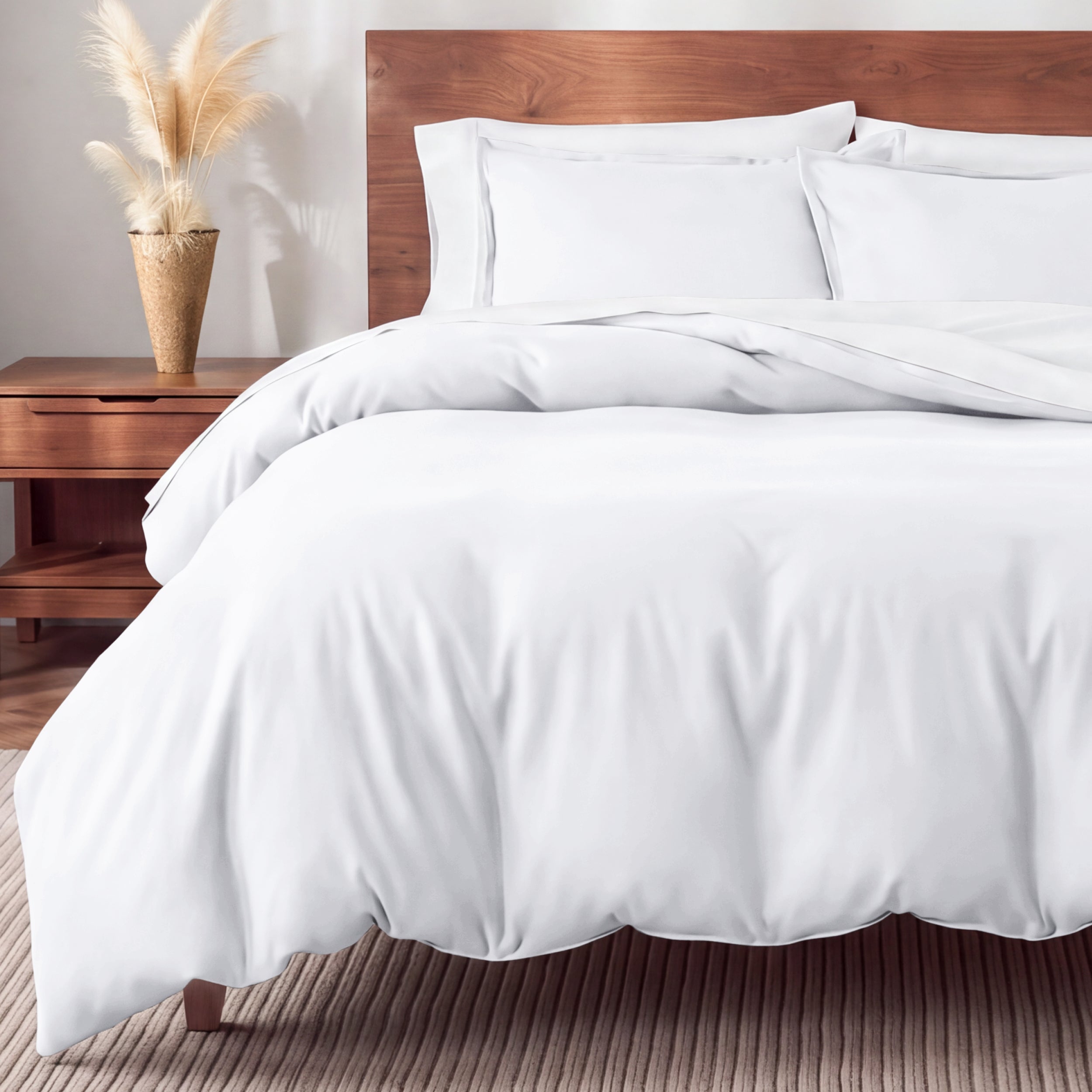 Flannel bedding set on a bed in a bedroom with a nightstand and lamp.
