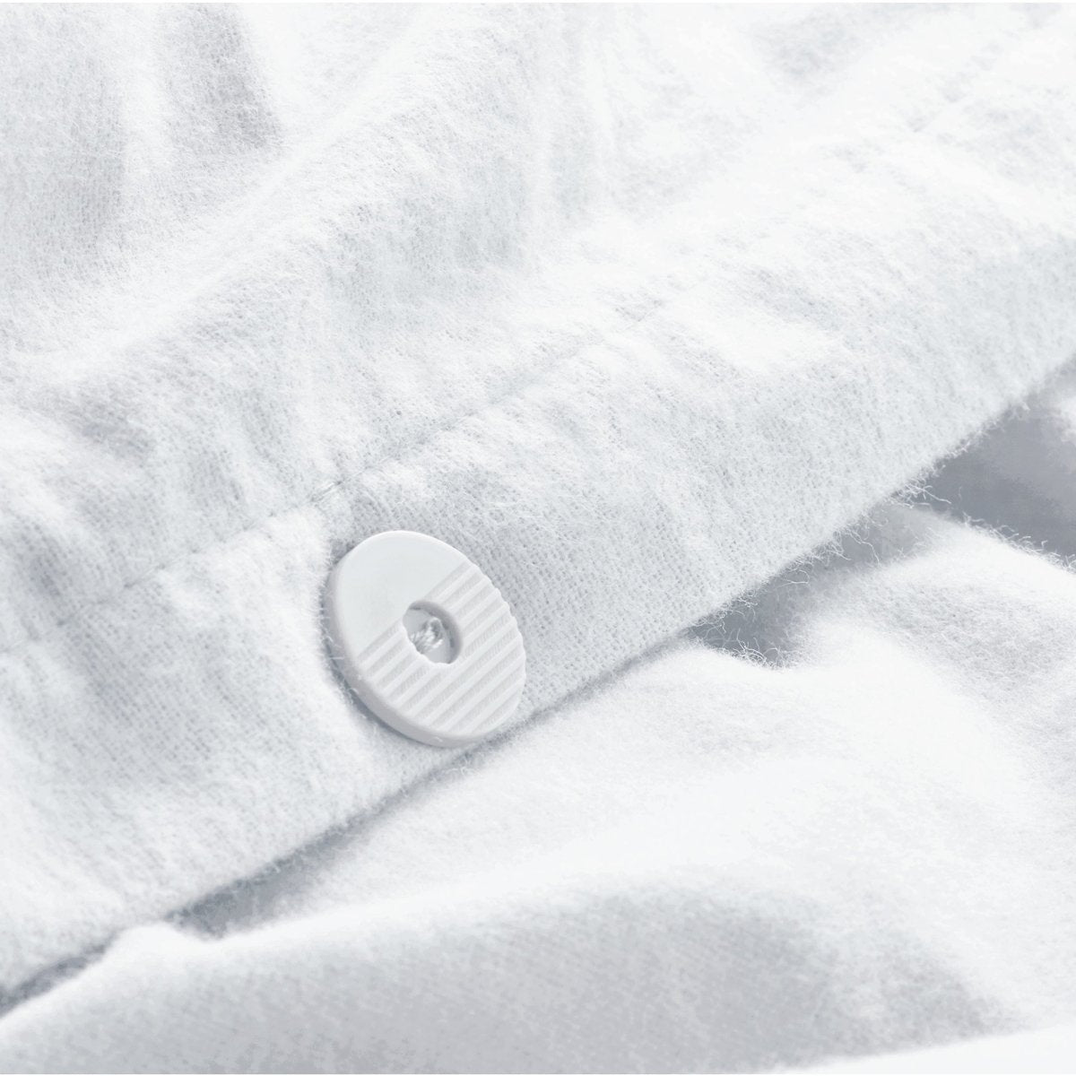 Close up of the button closure on a flannel duvet cover