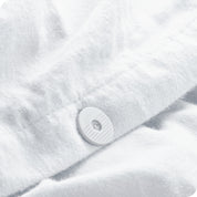 Close up of button for keeping duvet insert inside the flannel duvet cover