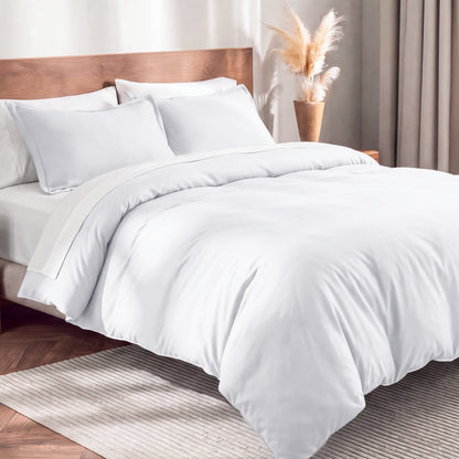Flannel duvet cover set on a bed in a bedroom with a lamp and plant in the background.
