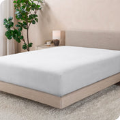 A modern bed with a flannel fitted sheet on
