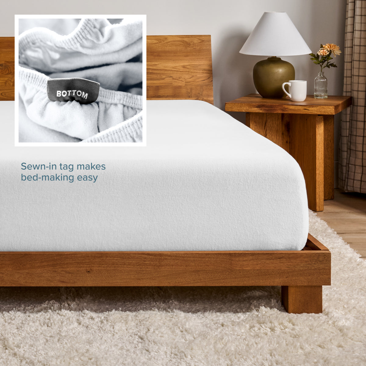 A flannel fitted sheet on a mattress with a wooden bed frame