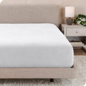 A close up of a modern bed with a flannel fitted sheet on