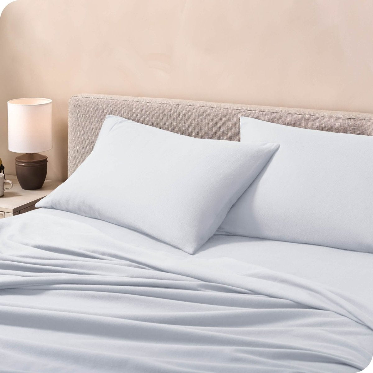 Flannel pillowcases on a mattress leaning against the headboard