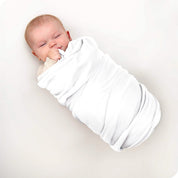 A baby swaddled in a receiving blanket
