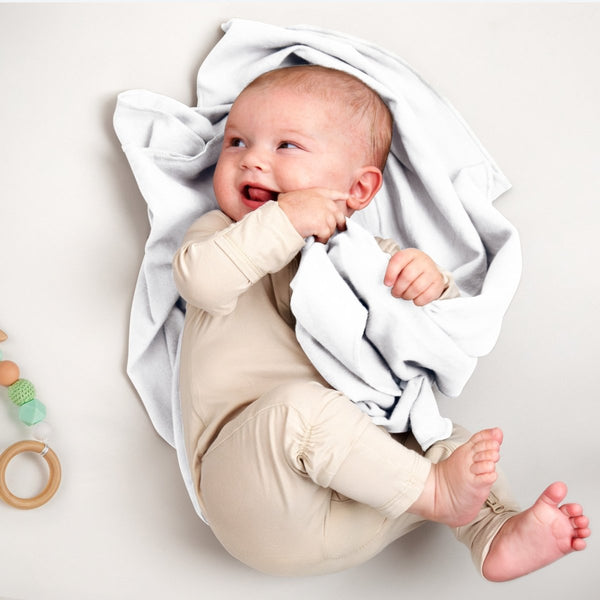 A baby lying on a flannel receiving blanket