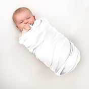 A baby wrapped in a flannel receiving blanket