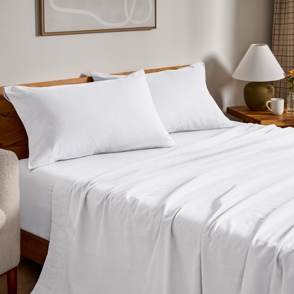 Flannel bed sheets and pillowcases on a bed in a bedroom setting.