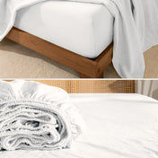 Fitted sheet on a wooden bed frame and folded fitted sheet.