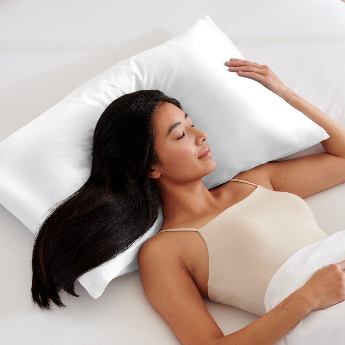 Woman lying on a white pillow