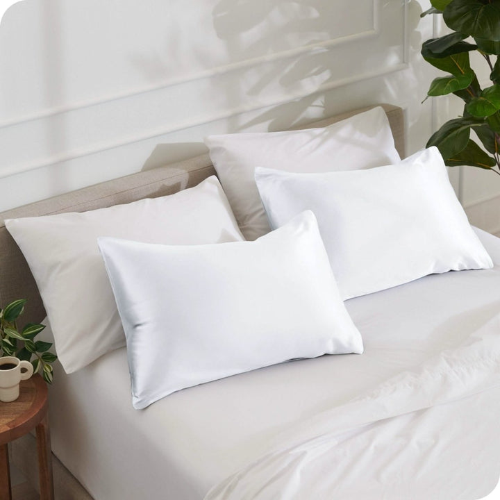2 mulberry silk pillowcases on pillows set on a bed